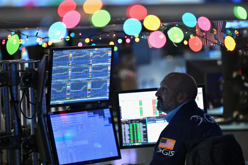 Traders work on the floor of the New York Stock Exchange (NYSE) during morning trading on December 14, 2023, in New York City.