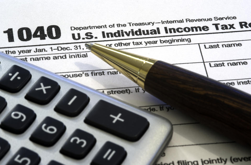 A 1040 income tax form. The pen obscures the year to add to the image usefulness.