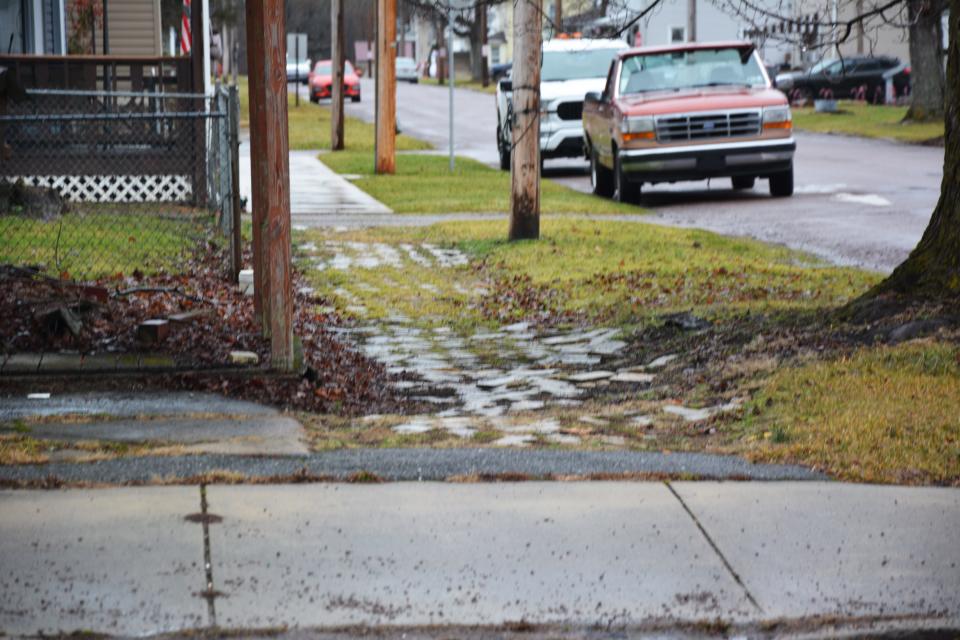 The sidewalks along Walker Street in Garrett show much wear and tear.