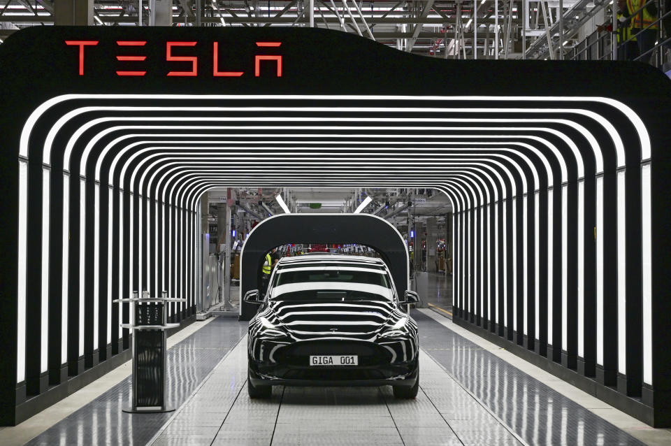 FILE - Model Y electric vehicles stand on a conveyor belt at the opening of the Tesla factory in Berlin Brandenburg in Gruenheide, Germany, Tuesday, March 22, 2022. Tesla production stands still because of The armed conflicts in the Red Sea and the associated shifts in transport routes between Europe and Asia. (Patrick Pleul/Pool via AP, File)