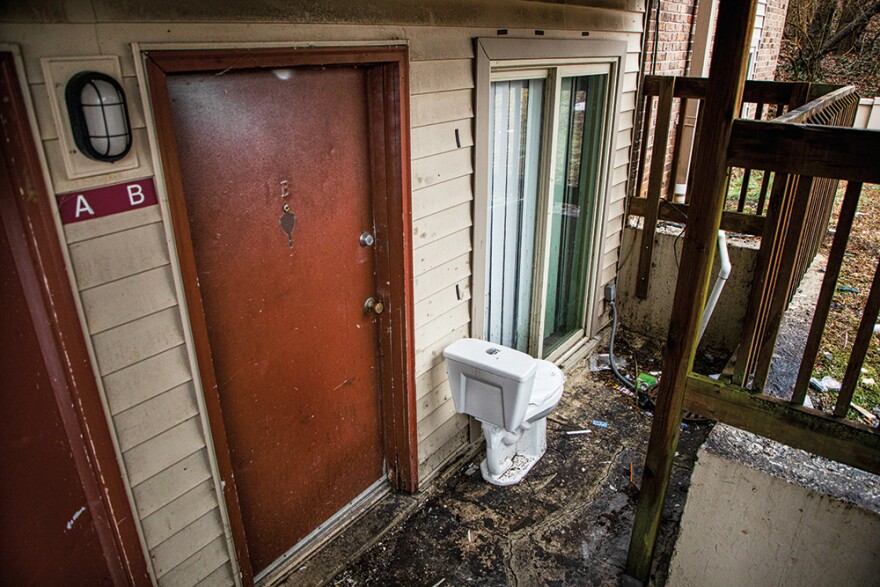 Trash and debris cover the ground outside of a vacant apartment on Tuesday, Jan. 23, 2023, at Pleasant View Gardens in Ferguson. All around the apartment complex, trash cans and sewers overflow with trash. 