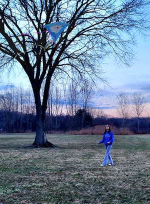 Emma Smith, soon to turn 15, flies a kite late in the afternoon at Bakers Field Park on Thursday, Feb. 8, 2024, in Port Huron Township. She and her family had opted to come to the park instead of flying them at home in close proximity to electrical wires.