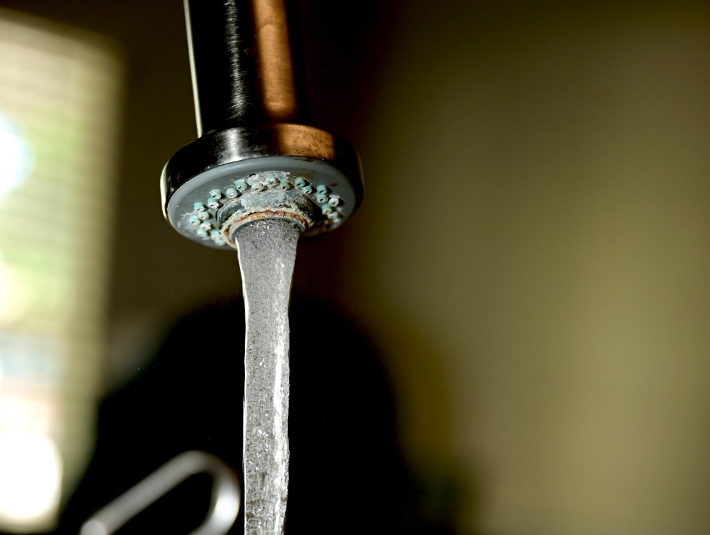 Water runs out of a household faucet in Pleasanton. (File photo by Chuck Deckert)