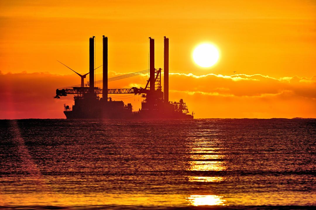 Vole Au Vent Offshore supply ship Jack up rig anchored in the  North sea off Blyth at sunrise with golden topped clouds and sun   just above