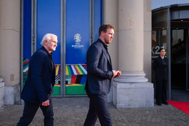 DFB sports director Rudi Voeller (L) and Germany national coach Julian Nagelsmann attend a dinner as part of the European Championship workshop for national coaches in the Standehaus. Marius Becker/dpa