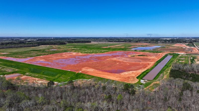 An aerial perspective of the Rivian Plant reveals slight activity among the heavy machinery following the corporation's recent announcement to suspend the extensive construction work at the Georgia site. Tuesday, March 19, 2024.Miguel Martinez /miguel.martinezjimenez@ajc.com