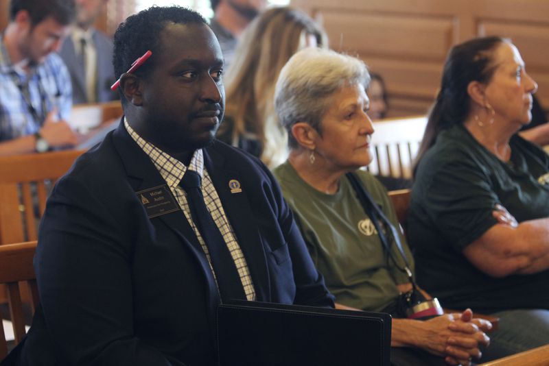 Michael Austin, a Kansas economist and a lobbyist for the free-market, small-government group Americans for Prosperity, awaits the start of a legislative hearing on a proposal that the group opposes to allow the state to issue bonds to help professional football's Kansas City Chiefs build a new stadium in Kansas, Monday, June 17, 2024, at the Statehouse in Topeka, Kan. For decades, economists who've studied professional sports have argued that government subsidies for new stadiums are not worth the cost. (AP Photo/John Hanna)