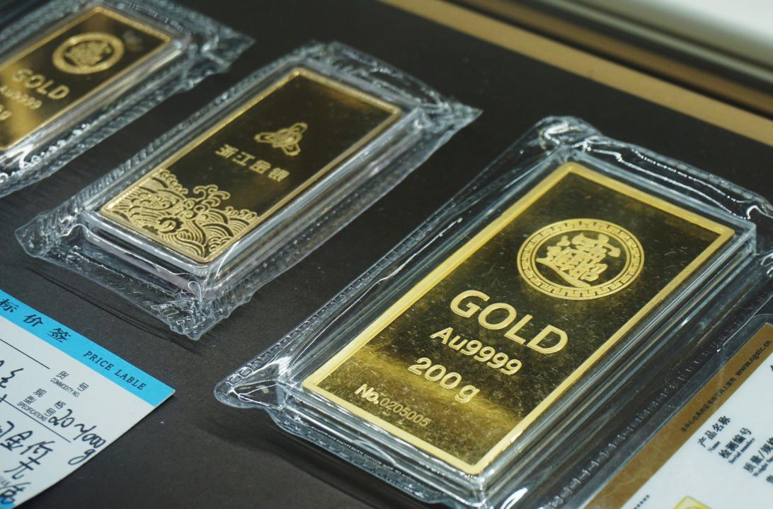 A view of a 200g gold bar for investment in a gold store in Hangzhou in east China's Zhejiang province Friday, Apr. 12, 2024. Geopolitical tensions have pushed gold prices over $2,400 per ounce. (FeatureChina via AP Images)