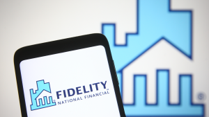 this photo illustration Fidelity National Financial (FNF) logo is seen on a mobile phone and a computer screen.