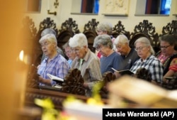 Sisters join in song during evening prayer at the Mount St. Scholastica Benedictine monastery in Atchison, Kan., Tuesday, July 16, 2024. (AP Photo/Jessie Wardarski)