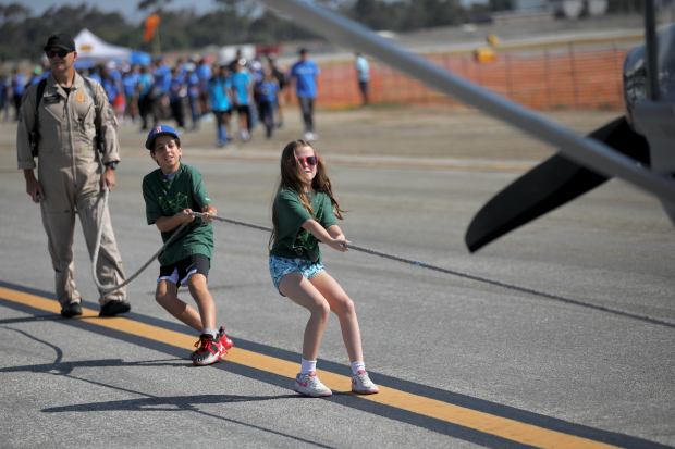 Youngsters pull a CHP 3,800-pound Gipps Airvan at Special Olympics...