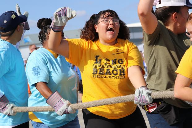 Special Olympics Southern California athletes react after pulling a 62-ton...