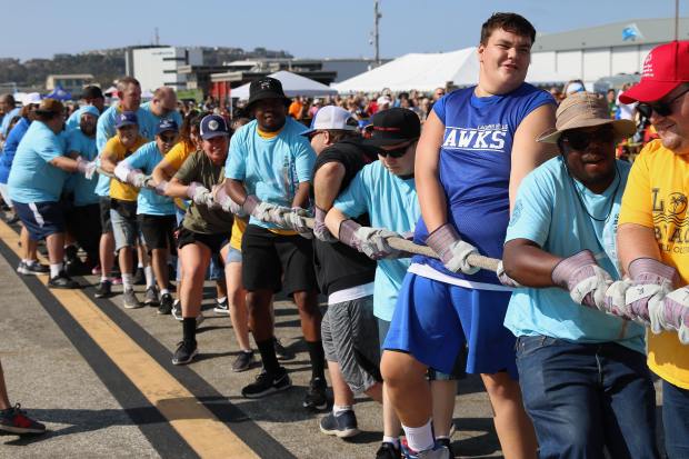 Special Olympics Southern California athletes team up to pull a...