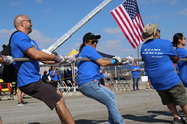 Kaiser Permanente employees pull a 62-ton UPS 757 jet 12...