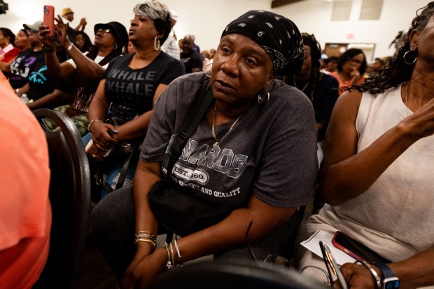 Dolton resident Latonya Bibbs reacts as she learns two officers within the Police Department were paid more in overtime pay than regular pay in fiscal years 2023 and 2024, during former Chicago Mayor Lori Lightfoot's presentation Aug. 8, 2024. (Tess Crowley/Chicago Tribune)