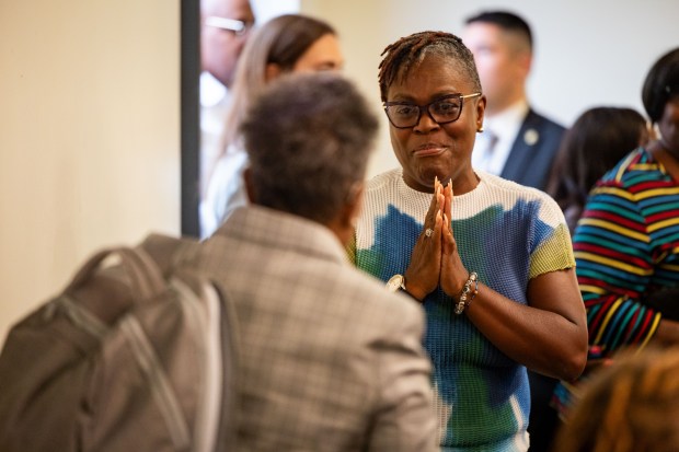 Dolton Trustee Tammy Brown thanks former Chicago Mayor Lori Lightfoot Aug. 8, 2024, after Lightfoot's presentation about the village's finances under Mayor Tiffany Henyard. (Tess Crowley/Chicago Tribune)