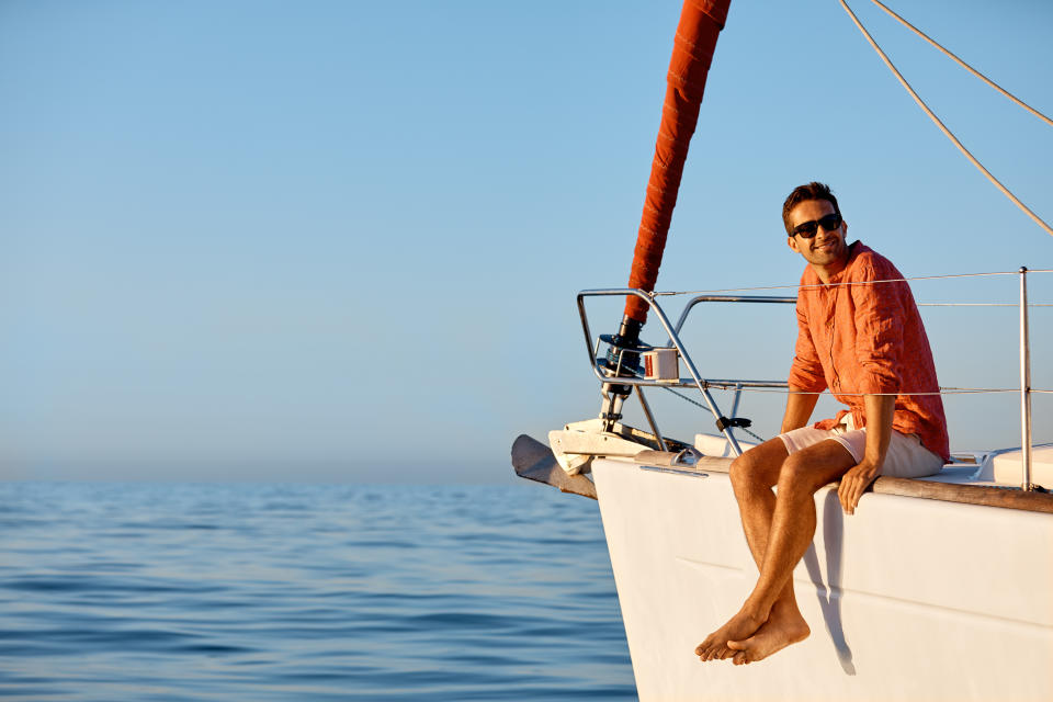 Shot of a young man going for an ocean cruise on a boat