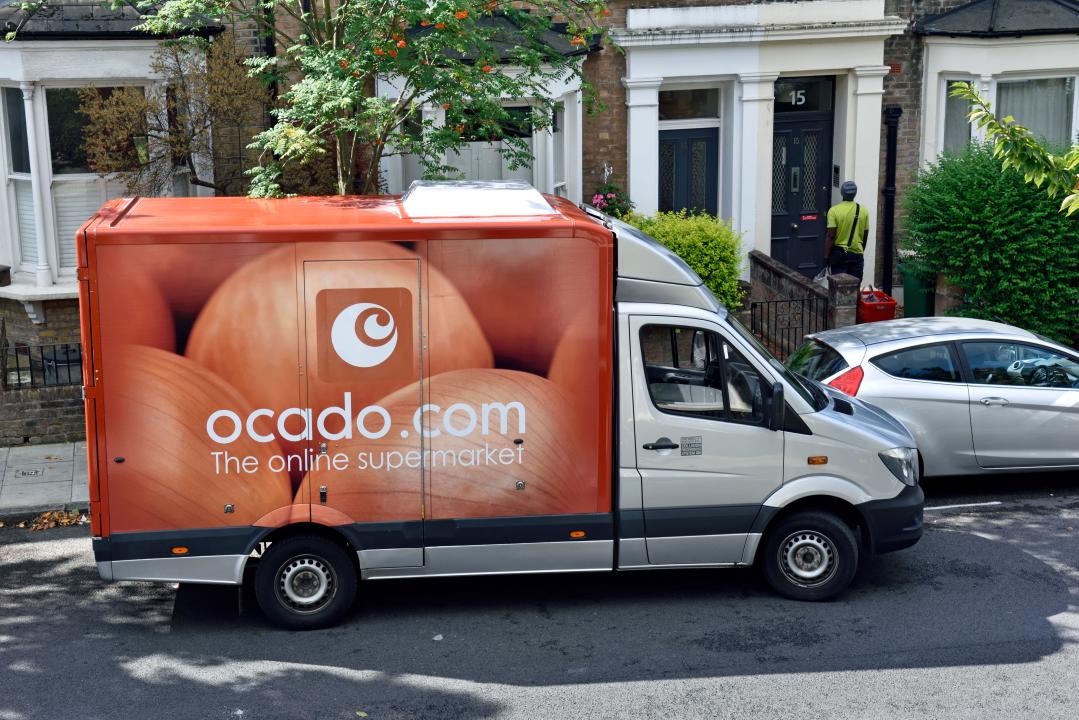 Ocado van with driver delivering to a street in Holloway, London Borough of Islington, England UK, August 2016.