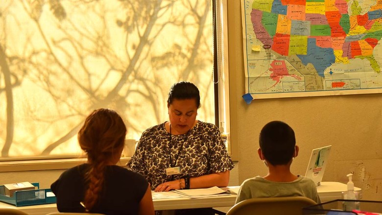 Laura Arroyo of Jewish Family Service meets with family members seeking asylum.