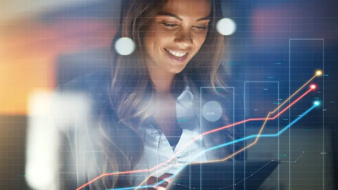 Business woman, tablet and stock market in double exposure for trading profit, increase and data growth at night. Happy trader, analyst or investor with finance graphs, arrow or statistics in overlay stock photo