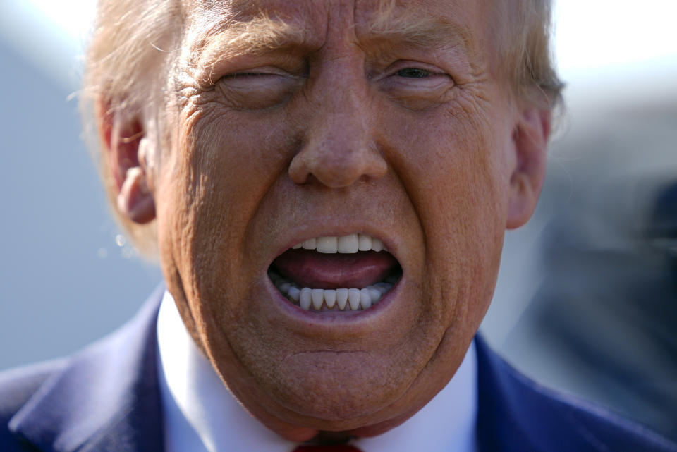 Republican presidential nominee former President Donald Trump speaks to reporters as he arrives at Detroit Metropolitan Wayne County Airport, Friday, Oct. 18, 2024, in Detroit. (AP Photo/Evan Vucci)