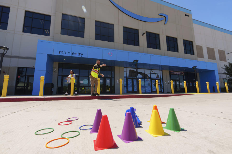 Amazon employees play during their lunch break outdoors at Amazon OXR1 fulfillment center in Oxnard, Calif., on Wednesday, Aug. 21, 2024. (AP Photo/Damian Dovarganes)