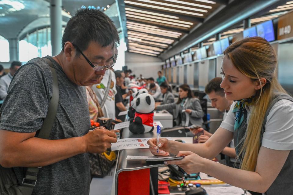 A passenger checks in at a desk decorated with panda toys at Istanbul Airport in Istanbul, Türkiye, on June 21, 2023. China's Sichuan Airlines Wednesday resumed service to Türkiye after the pandemic, with a plane taking off from Istanbul Airport to the southwestern Chinese city of Chengdu. (Photo by Omer Kuscu/Xinhua via Getty Images)