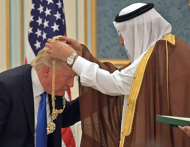 President Donald Trump (C) receives the Order of Abdulaziz al-Saud medal from Saudi Arabia's King Salman bin Abdulaziz al-Saud