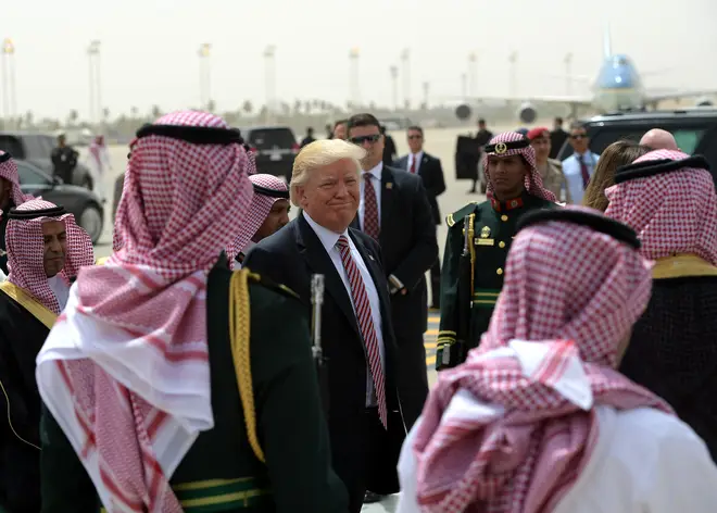 US President Donald Trump (C) makes his way to board Air Force One in Riyadh