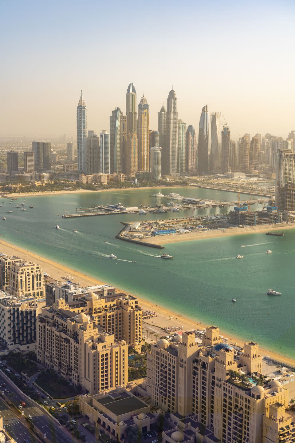 united arab emirates, dubai, buildings of palm jumeirah with marina and downtown skyscrapers in background