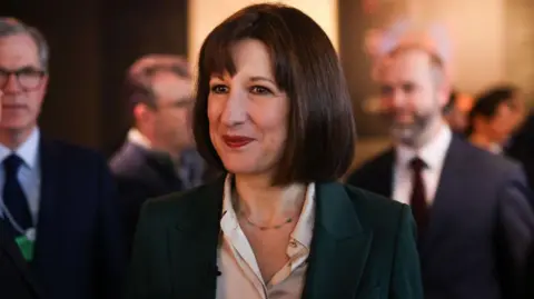 Getty Images Chancellor Rachel Reeves smiling at Davos in a busy room