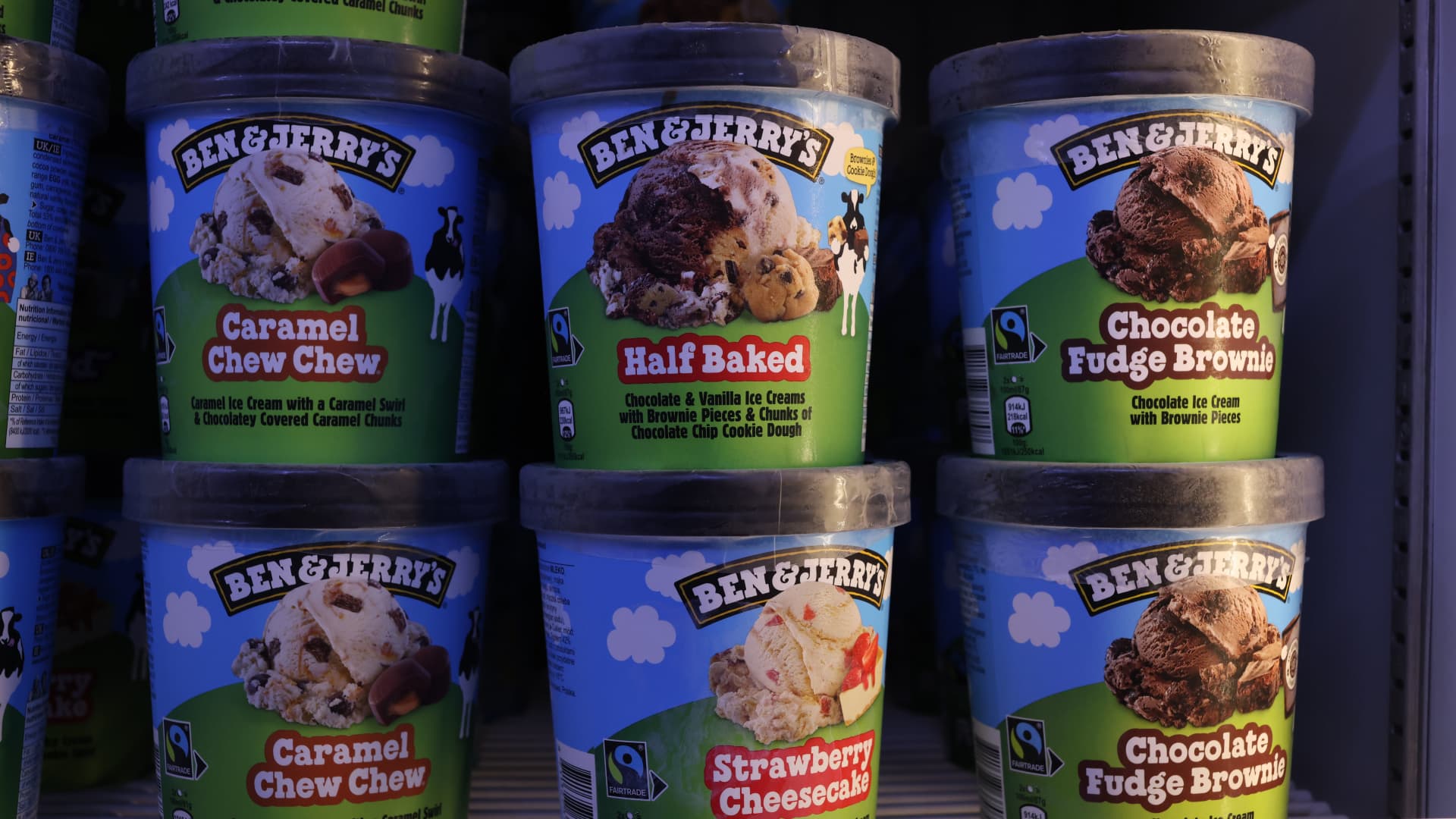 Tubs of Ben & Jerry's ice cream in a store freezer.