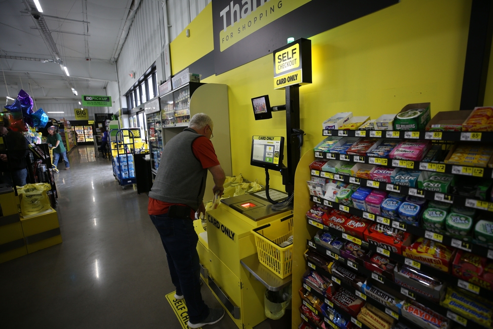 A man using the self-checkout kiosk at Dollar General