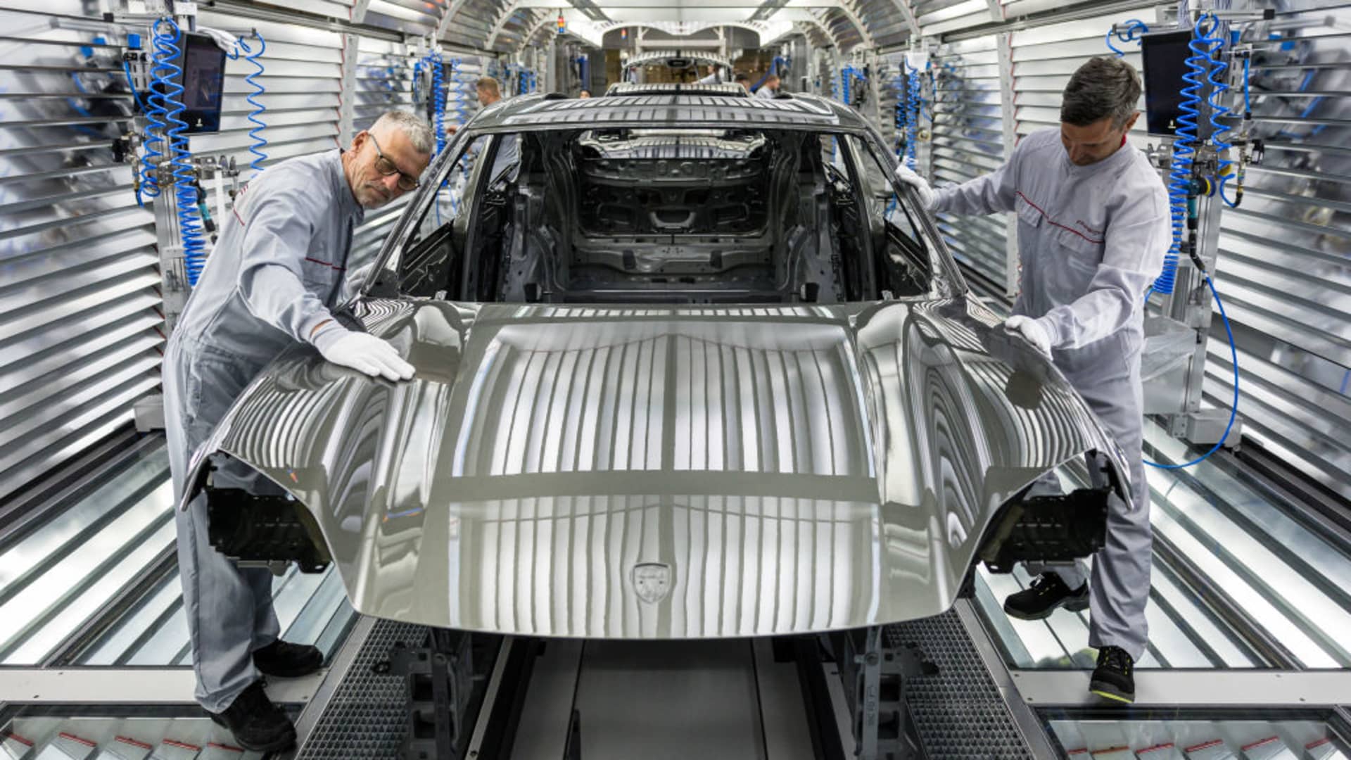 Workers assemble the new all electric Porsche Macan at the Porsche assembly plant on May 6, 2024 in Leipzig, Germany.