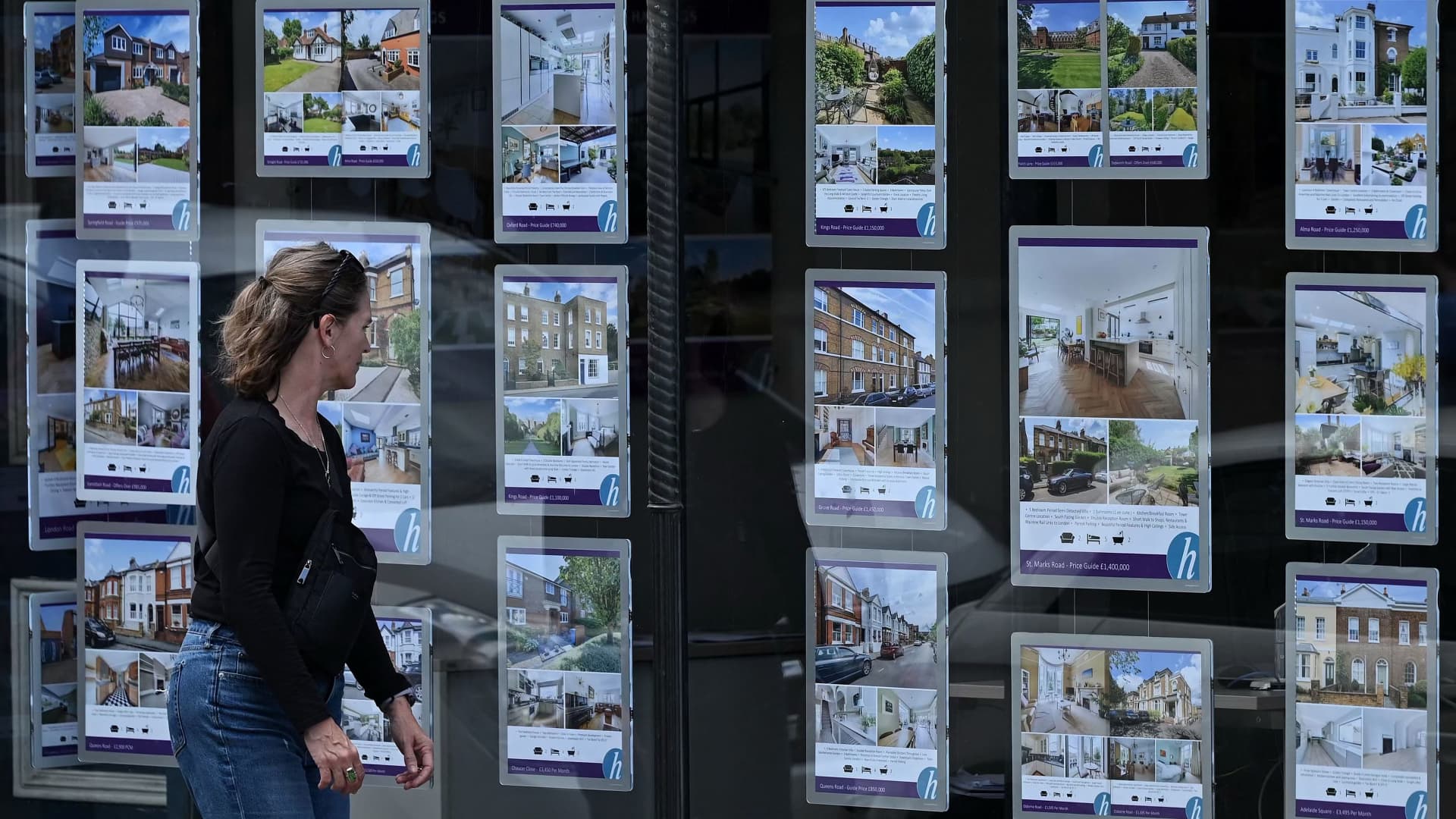 Residential properties for sale displayed in the window of an estate agent in Windsor, west of London.