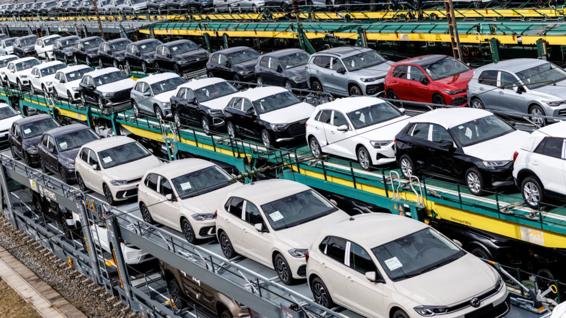 Numerous car transport wagons with new vehicles from Audi and Volkswagen stand on the tracks of a marshalling yard in Munich (Bavaria) on March 25, 2025.