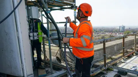 Getty Images Telecom engineers replacing Huawei Technolgies Co. components with Nokia Oyj 5G network systems on the mobile network antenna array atop Muswell Court tower block in Hull. 