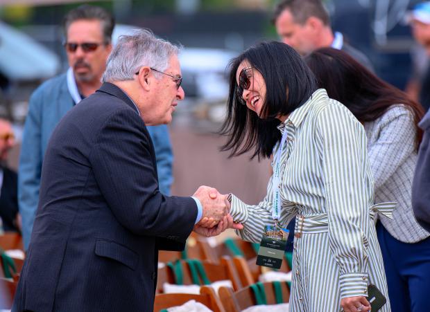 Irvine Mayor Larry Agran, left, greets Tina Lee, CEO of...