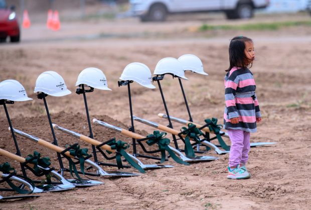 Victoria Pham, 3, checks out the shovels and hard hats...