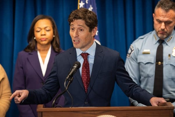 A man speaks at a podium 