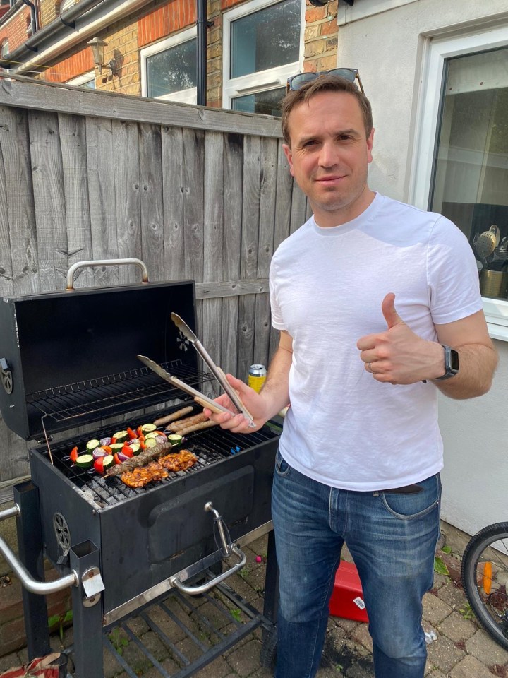 Man grilling vegetables and meat on a barbecue.