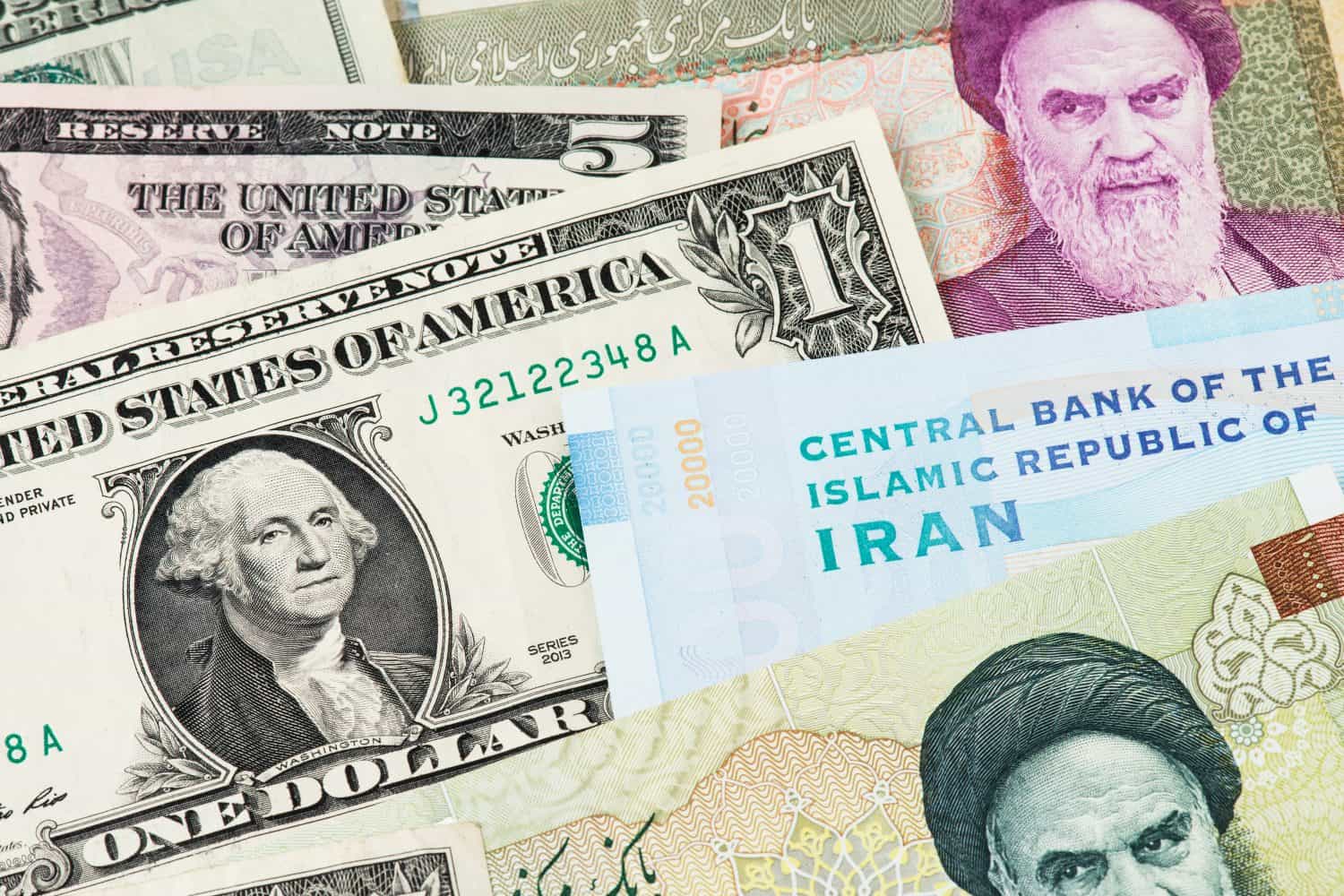 US Dollar and Iran Rial currency banknotes. USA vs IRAN