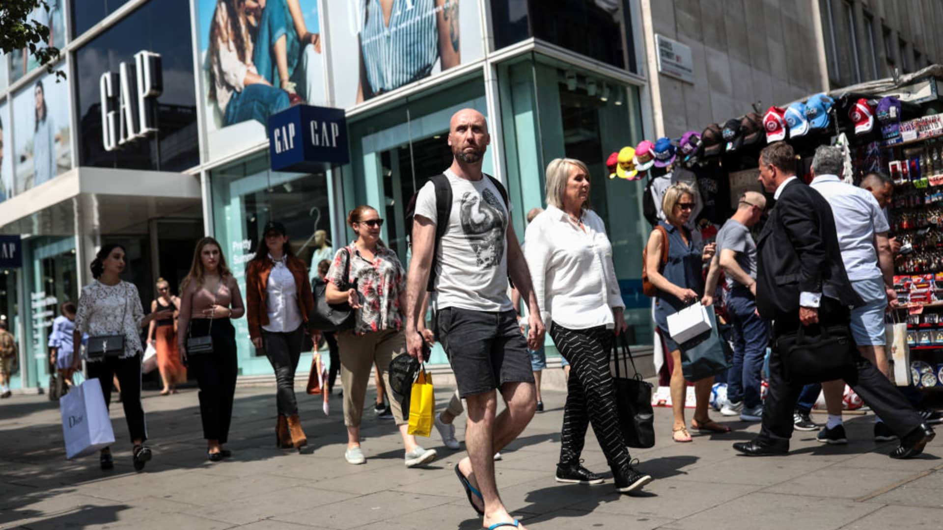 Shoppers walk past a Gap Inc. clothing store in London, U.K., on Thursday, May 25, 2017.