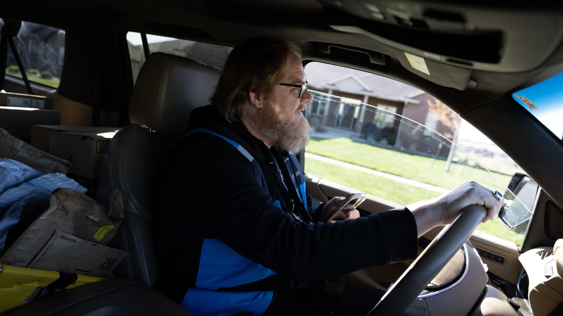 Todd Niggeling delivers packages for Amazon in Sioux City, Iowa, on Tuesday, May 2, 2023. Niggeling delivers packages through Amazon's delivery hub program in which Amazon is using small businesses as centralized drop-off points and paying business owners to drive the last mile to deliver those packages instead. 