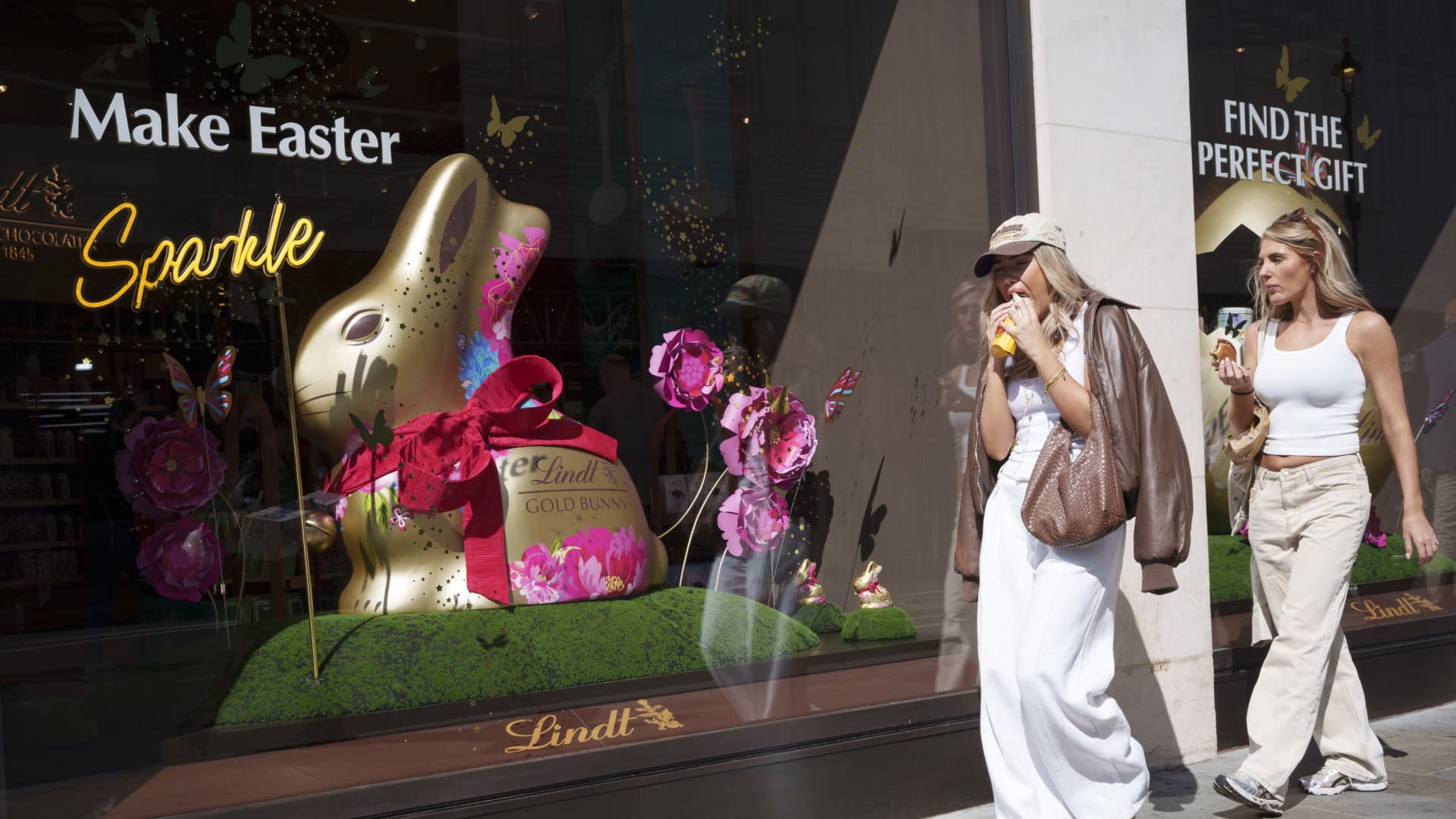 Shoppers walk past the Lindt chocolate shop at Piccadilly Circus on 2nd April 2025, in London, England.