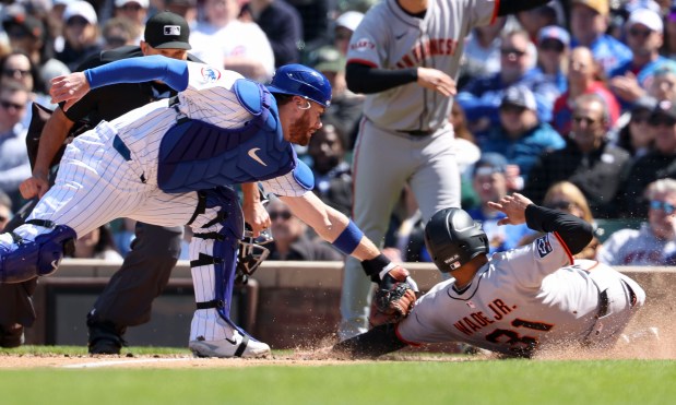 Chicago Cubs catcher Carson Kelly tags San Francisco Giants first base LaMonte Wade Jr. out at the plate to end the top of the fourth inning Wednesday, May 7, 2025, at Wrigley Field. (Brian Cassella/Chicago Tribune)