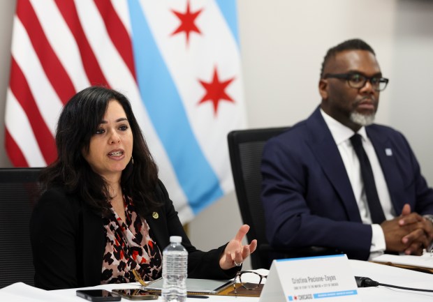 Chicago Mayor Brandon Johnson, right, listens as his chief of staff Cristina Pacione-Zayas answers questions during a press conference at City Hall on April 1, 2025. (Eileen T. Meslar/Chicago Tribune)