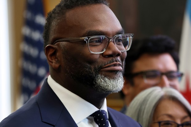 Chicago Mayor Brandon Johnson smiles while talking to reporters after a City Council meeting on May 7, 2025. Council members approved Johnson's affordable housing plan. (Terrence Antonio James/Chicago Tribune)