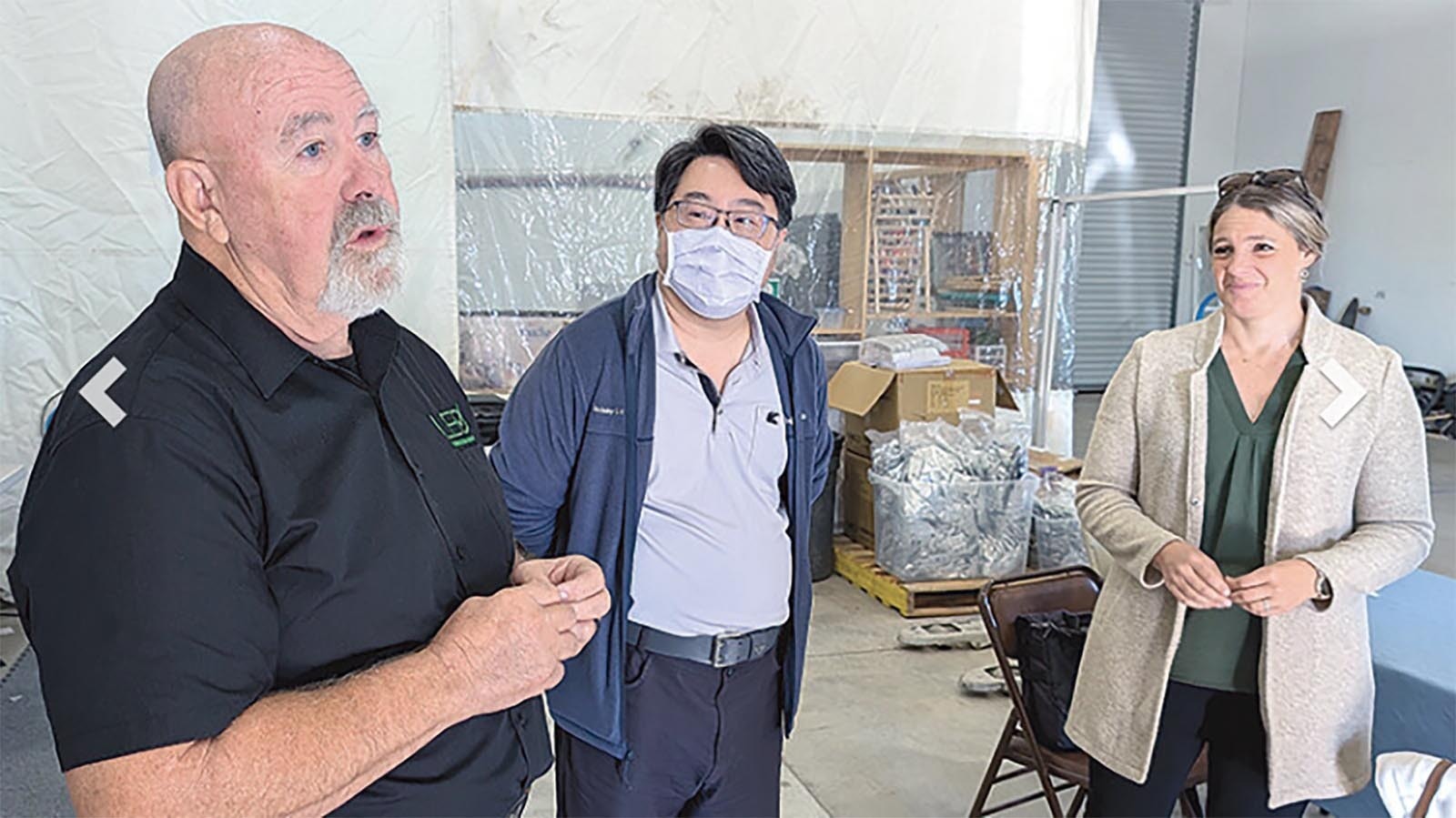 Seaton Smith, from left, Leo Chen and Kristin Fong of the Wyoming Business Council discuss the gluten testers made for a Powell, Wyoming, company in Taiwan.
