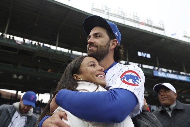 Cubs shortstop Dansby Swanson hugs his wife, Stars forward Mallory Swanson, on opening day at Wrigley Field on March 30, 2023. (John J. Kim/Chicago Tribune)